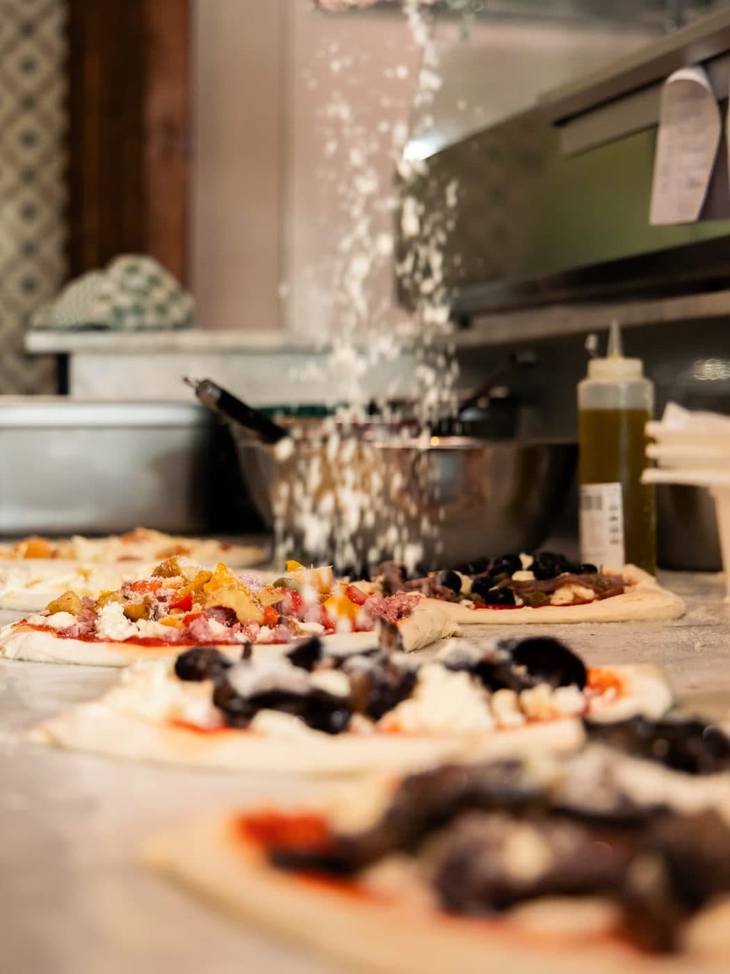 Pluie de parmesan sur une pizza napolitaine